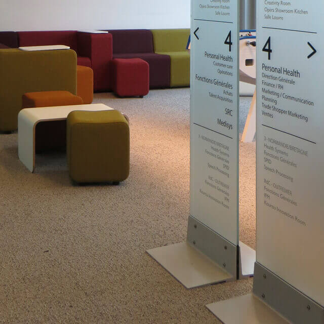Information d’étage et flèche signalétique dans un espace de travail d’un siège social